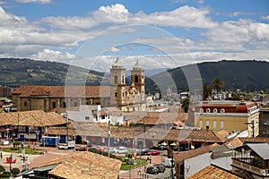 View over historic town Zipaquira with colonial buildings, Parque principal, Cathedral of Zipaquira and mountains, blue sky with