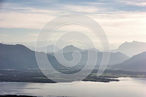 view over Lake Chiemsee to the Alps with clouds and blue sky