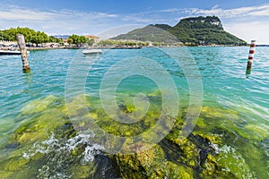 View over lake at Garda village and port with boats