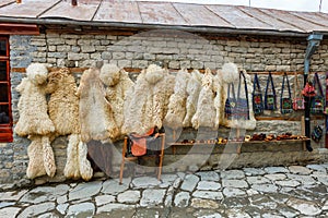 View over local street in Lahich, shop with bags, souvenirs and herbs. Traditional caucasus sheepskin fur