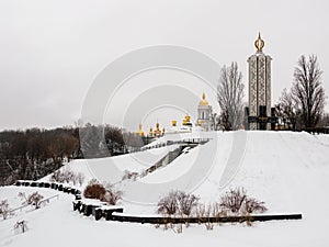 View over National Museum of Holodomor Genocide or famine victims memorial and golden domes of Kiev Pechersk Lavra or Kyiv
