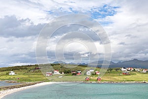 View over a Norwegian fjord to an island with fishing huts and r