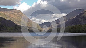 View over Padarn Lake, Llanberis, Snowdonia in Wales with the historic castle Dolbadarn remains in background