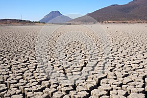 View over parched and empty dam, with cracked mud