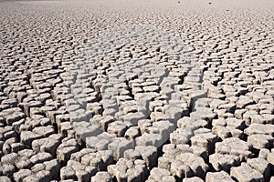 View over parched and empty dam, with cracked mud