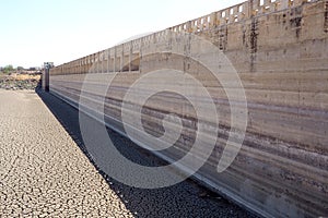 View over parched and empty dam, with cracked mud