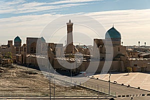 View over the Poi Kalon Mosque and Minaret from Ark fortress, in Bukhara, Uzbekistan. Blue sky