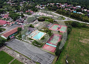 View over a public park with many residential houses in the distance.