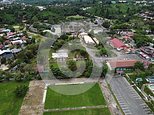 View over a public park with many residential houses in the distance.