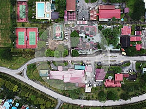 View over a public park with many residential houses in the distance.