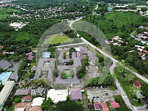 View over a public park with many residential houses in the distance.