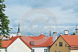 A view over red tile roofs of white and yellow houses of Tallin