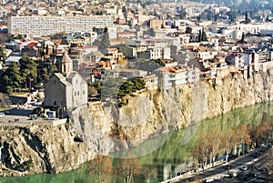 A view over the roofs of old houses, Mtkvari Kura river and Metekhi church in the center of Tbilisi