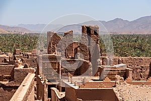 View over the roofs of Tamenougalt village with its typical clay houses, the Draa valley in the background