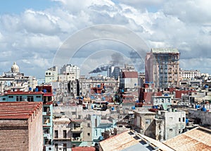 View over the rooftops of Havana, Cuba with oil refinery in distance