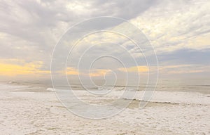 View over sandy beach of Atlantic Ocean with waves crashing and make the splashing water and white air foam bubble at