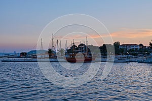 View over  a seashore in Halkidiki Greece at sunset with cruisers and fishing boats