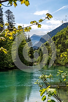 View over the slightly dammed up, turquoise shimmering river Archbach on a wonderful sunny day