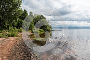 View over a small natural sandy beach at the shore of the Ljusnan river