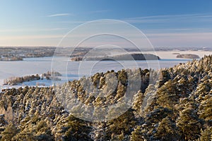 View over snowy trees and frozen lake in Tampere