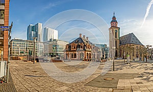 View over the square at the Hauptwache in Frankfurt with St. Catherine's Church and skyscrapers of the skyline in