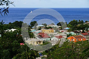 A view over St. Kitts capital, Basseterre with residential buildings and blue sea water on the background