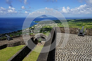 A view over St. Kitts and Sint Eustatius Islands with Brimstone Hill Fortress fortifications on the foreground on a bright sunny