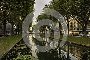 View over the water lined with trees at KÃ¶nigsallee, Dusseldorf, Germany.