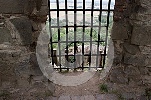 A view over window with grids to the landscape.