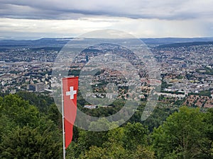 View over Zurich from Uetliberg with Swiss Flag