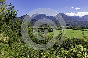 View overlooking the Na Pali coast and fields in the Hanalei River valley Princeville Kauai Hawaii USA photo