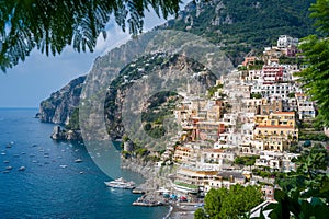 View from palm tree branches to Positano village