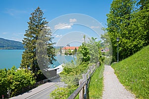 View from panorama path to Tegernsee lake and castle, tourist destination bavaria