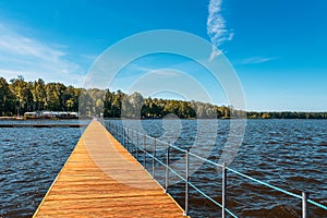 view of the paprocaÅ„skie lake in Tychy. Wooden platforms in the foreground. Water plants and sailboats. A beautiful sunny day.