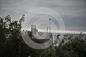 View of Paris from Montmartre with Eiffel Tower against an overcast sky.