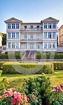 View from the park to an old Baltic house on the beach promenade Zinnowitz on the island of Usedom photo