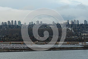 View on parked new cars and cargo train from ship container terminal in Vancouver, Canada.