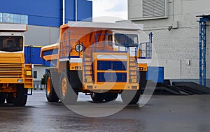 View of the parking lot of an exhibition of large career heavy dump trucks at the automobile plant Belaz