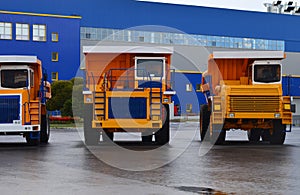 View of the parking lot of an exhibition of large career heavy dump trucks at the automobile plant Belaz