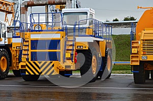 View of the parking lot of an exhibition of large career heavy dump trucks at the automobile plant Belaz