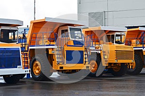 View of the parking lot of an exhibition of large career heavy dump trucks at the automobile plant Belaz