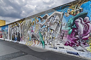 View of part of the old existing Berlin Wall, covered with graffiti made by people from all over the world.