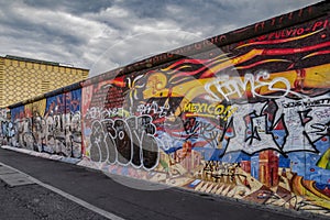 View of part of the old existing Berlin Wall, covered with graffiti made by people from all over the world.