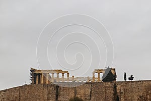 View of Partenon on Acropolis above retaining wall outlined against a grey sky from Acropolis Museum - Room for Copy photo