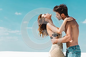 View of passionate sexy young couple embracing on beach