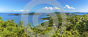 A view past lush vegetation towards the islands of Guana, Great Camanoe and Scrub from the main island of Tortola