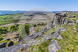 A view past millstone outcrops from the highest point on the top of the Stanage Edge escarpment in the Peak District, UK