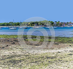 A view past mud flats at low tide across the River Hamble