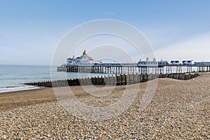A view past sea defenses towards the pier at Eastbourne, UK