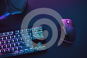 View of pastel neon color backlighted computer keyboard and mouse from above